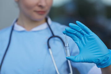 female doctor holding a vial