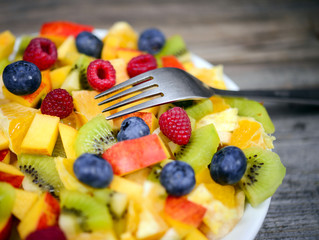 Macro shot of a fresh fruit salad with bananas kiwi orange blueb