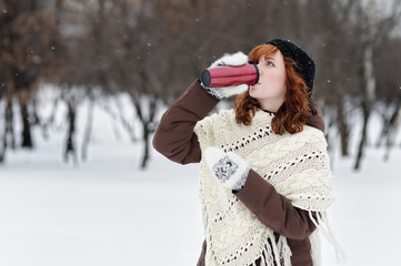 Young beautiful woman in winter park