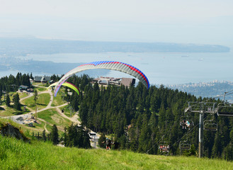 Fototapeta na wymiar Paragliders Take off from Grouse Mountain Vancouver