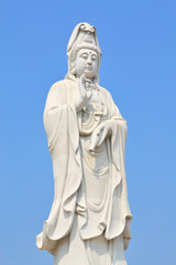 Fototapeta na wymiar Big Standing Guan Yin on blue sky