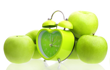 Green alarm clock heart shape and apples