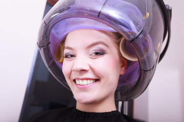 Smiling woman hair rollers curlers hairdryer 