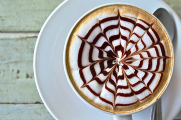 hot milk art coffee on wooden table