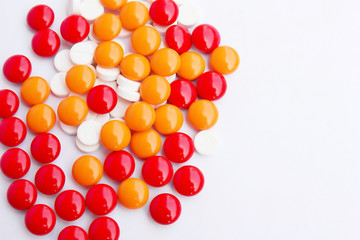 Pills pouring out on a white background