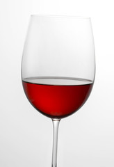 Glass half full of red wine