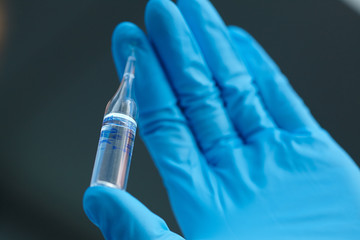 female doctor holding a vial