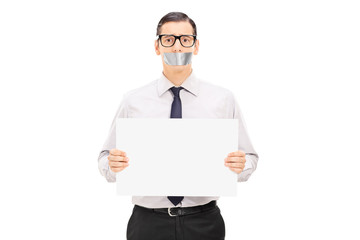 Male hostage holding a blank banner