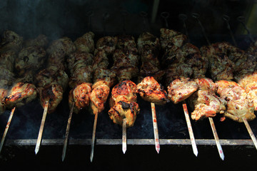 Shish kebab on the grill with smoke.