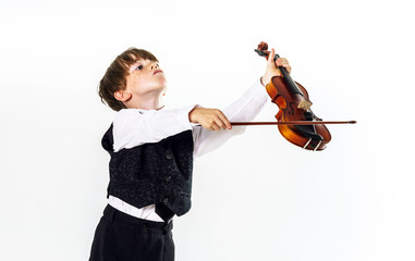 Red-haired preschooler boy with violin