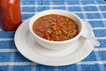 Chili in White Bowl with Spoon and Hot Sauce