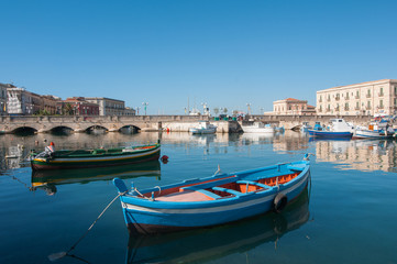 Fototapeta na wymiar View of Umberto I bridge in Siracuse and fishing boats