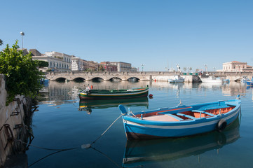 View of Umberto I bridge in Siracuse and fishing boats