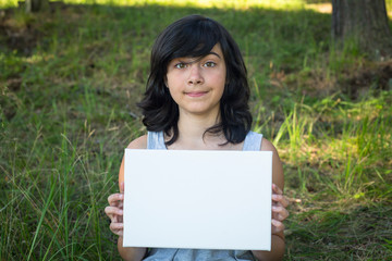 Girl holding clean white sheet paper(banner for message)