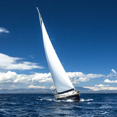 Fototapeta na wymiar Sailing in the wind through the waves. Luxury yachts..