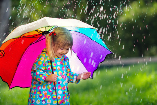 Funny Cute Toddler Girl Wearing Raincoat With Colorful Umbrella