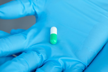 female doctor holding medicine capsules