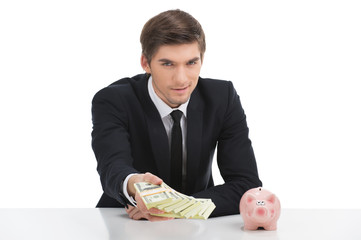 Business man holding dollar bills, isolated on white.