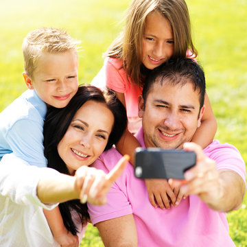 family taking selfie with smartphone