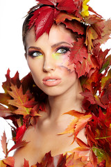 Autumn woman dressed in red leaves