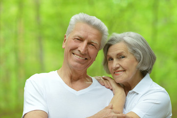 Beautiful elderly couple in summer park
