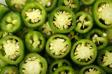 sliced green jalapeno peppers background - obrazy, fototapety, plakaty