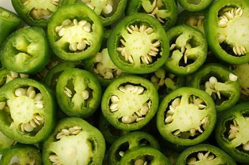 Foto op Plexiglas sliced green jalapeno peppers background © phloen