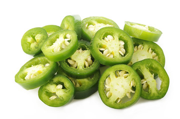 sliced green jalapeno peppers on white background - obrazy, fototapety, plakaty
