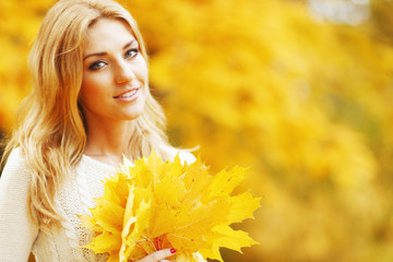 Smiling woman in autumn park