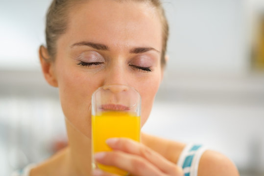 Young woman drinking fresh orange juice
