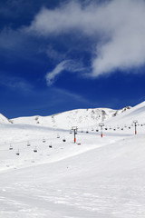 Chair-lift and ski slope at sun day