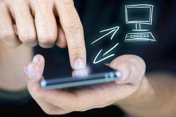 Man synchronizing his mobile and desktop
