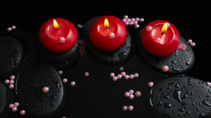 Beautiful spa still life of candles, zen stones with drops and p