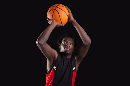 Basketball player dunking on black background - Powered by Adobe