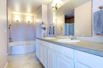 Refreshing light lavender bathroom with white cabinet
