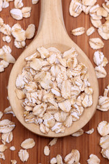 Rolled oats in a wooden spoon