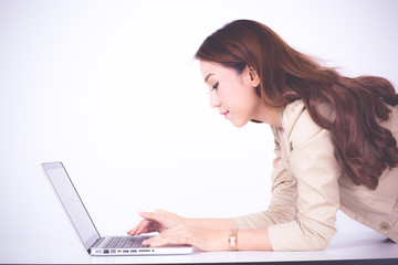 Portrait of a young business woman using laptop at office