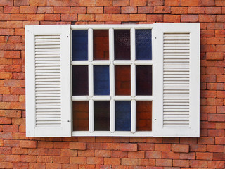 Beautiful white wooden window on old brick wall