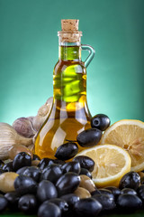 Healthy olive oil with black and green olives, lemon and garlic