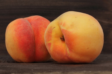 Naklejka na ściany i meble two fresh peaches on wooden background