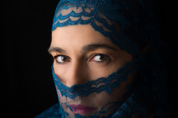 Middle Eastern woman portrait looking sad with blue hijab artist