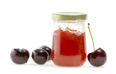Jam in bottle and nectarines on white background.