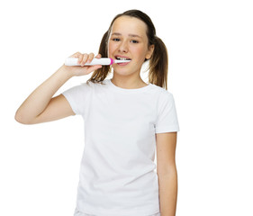 Girl brushing her teeth with an electric brush
