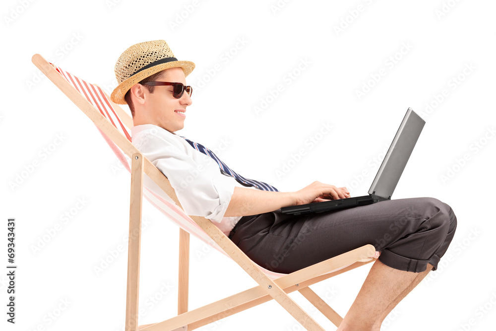 Wall mural Casual businessman working on laptop