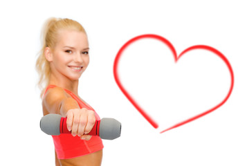 smiling beautiful sporty woman with dumbbell