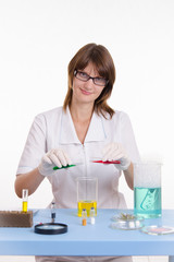 Chemist mixes the two liquids