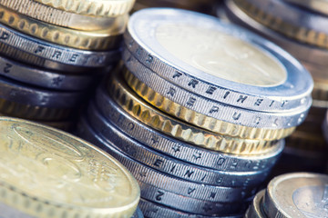 Euro coins on pile of other coins in background.Macro