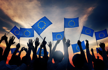 Group of People Waving European Union Flags in Back Lit - obrazy, fototapety, plakaty
