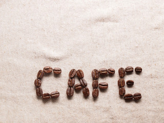 Fototapeta na wymiar coffee crop beans on fabric textile texture background