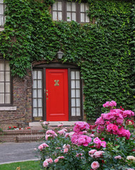 red front door with vines and roses
